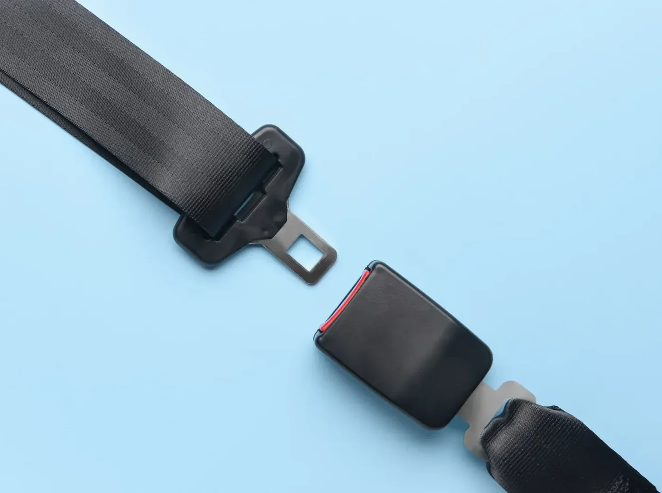 Complete replacement seat belt assembly with latch plate and buckle shown on a plain studio background